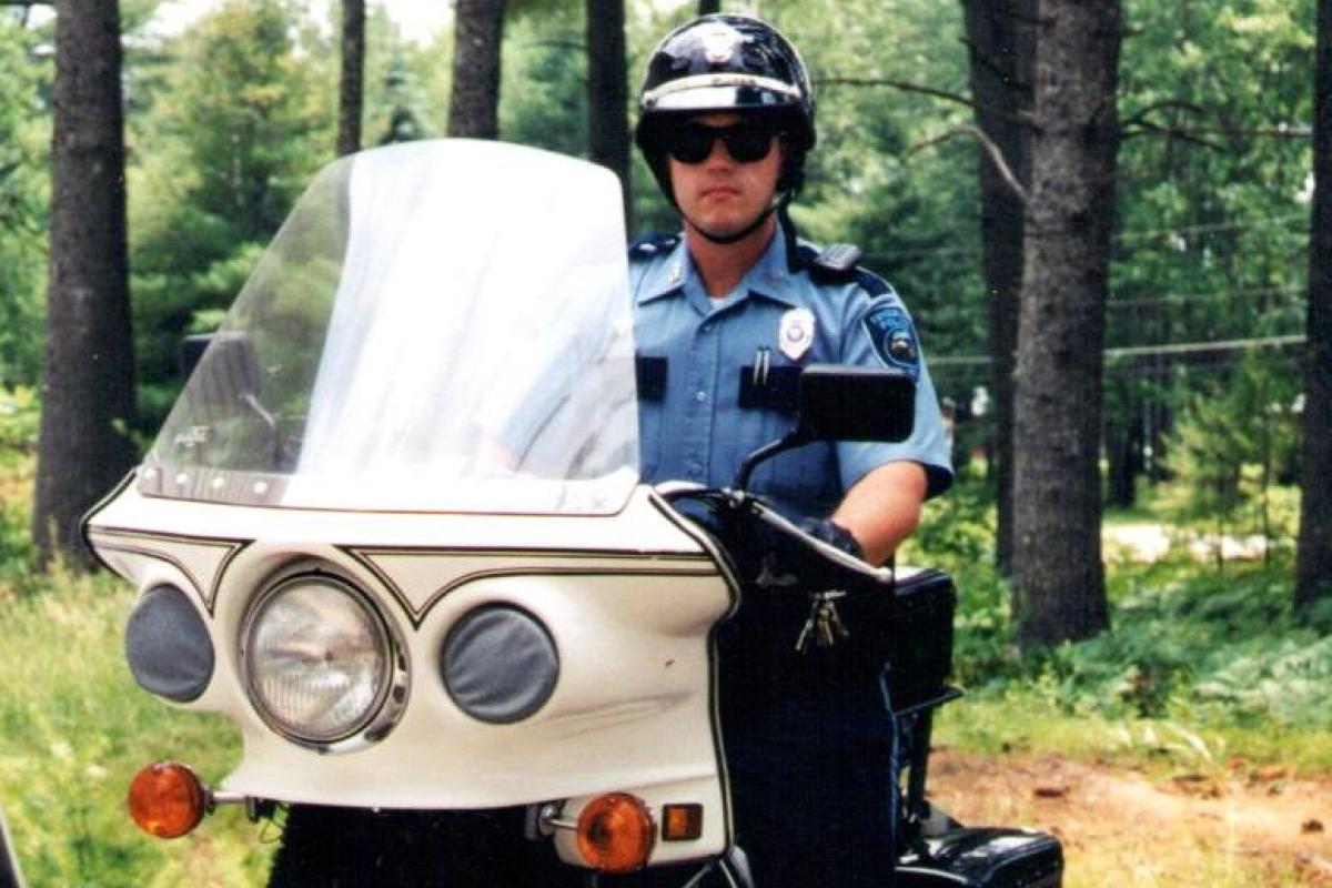 Police Officer on Motorcycle in Woods